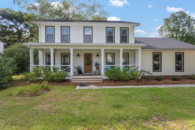 view of front of house with a front yard and covered porch