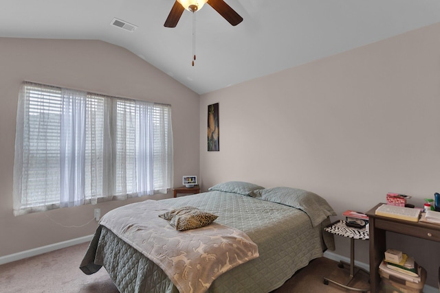 carpeted bedroom featuring ceiling fan, vaulted ceiling, and multiple windows