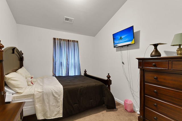 carpeted bedroom featuring lofted ceiling