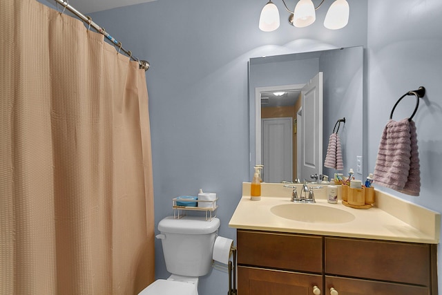 bathroom with large vanity and toilet