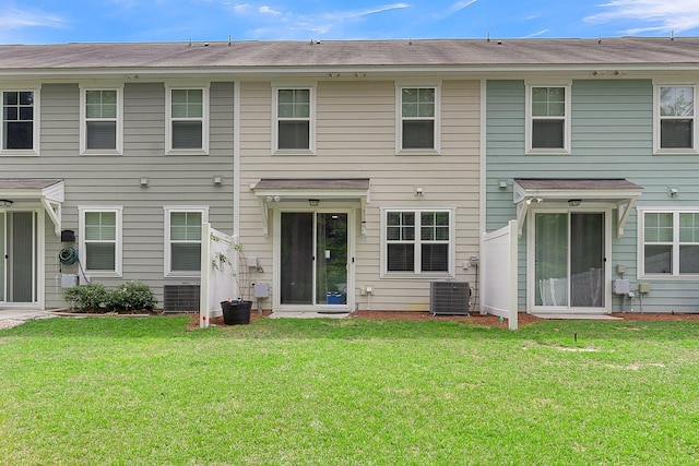 exterior space featuring central air condition unit and a front yard