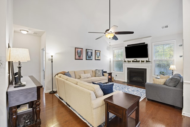 living room featuring ceiling fan, dark wood-type flooring, and vaulted ceiling