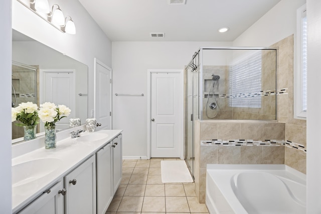 bathroom with tile patterned flooring, plenty of natural light, vanity, and independent shower and bath