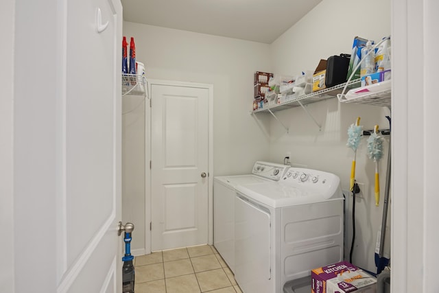 clothes washing area featuring light tile patterned floors and independent washer and dryer