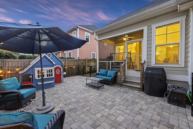 patio terrace at dusk with area for grilling and an outdoor hangout area