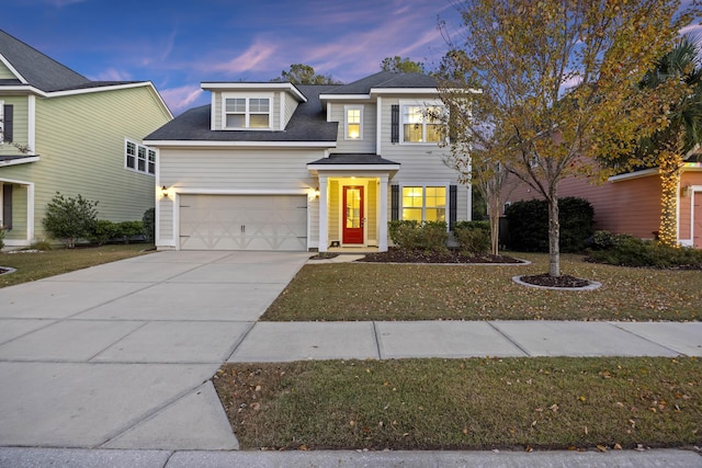 view of front facade with a lawn and a garage