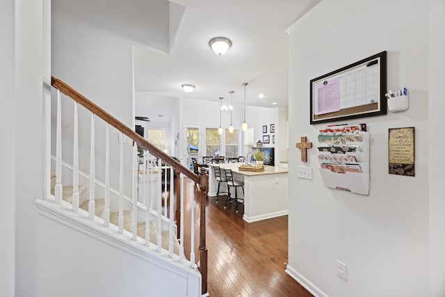 entrance foyer featuring dark hardwood / wood-style floors and an inviting chandelier