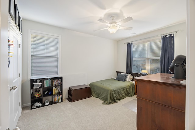 carpeted bedroom featuring ceiling fan