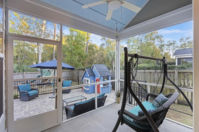 sunroom / solarium with ceiling fan and lofted ceiling