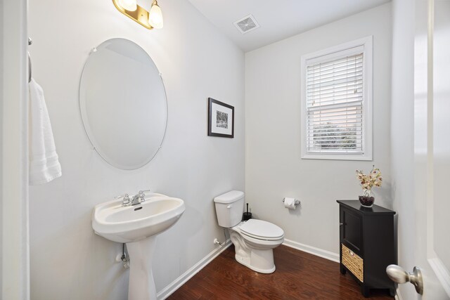 bathroom featuring hardwood / wood-style flooring, toilet, and sink