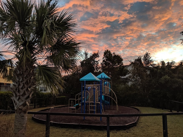 playground at dusk with a lawn