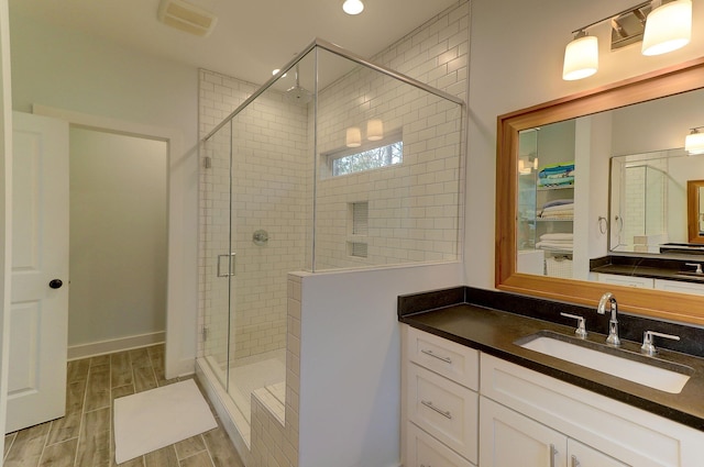 bathroom featuring vanity and walk in shower