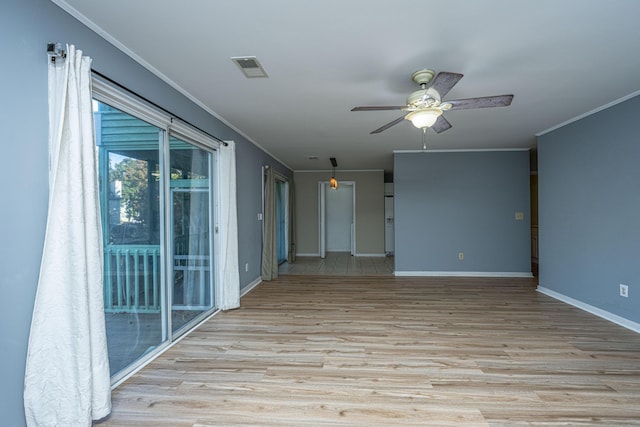 spare room featuring ceiling fan, crown molding, and light hardwood / wood-style floors