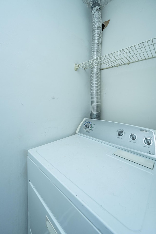 clothes washing area with washer / dryer