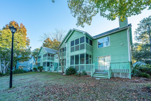 rear view of property with a balcony