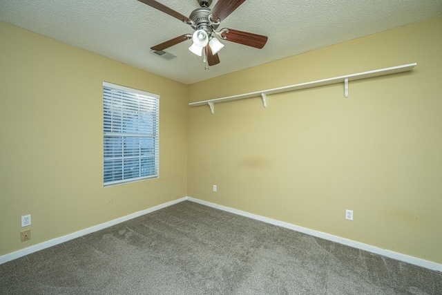 unfurnished room featuring carpet, ceiling fan, and a textured ceiling