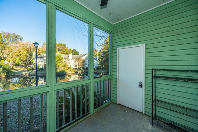 unfurnished sunroom with ceiling fan