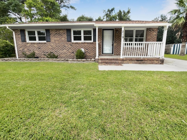 ranch-style home with brick siding, a porch, and a front yard