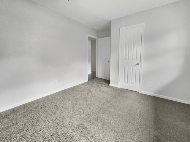 unfurnished bedroom with baseboards and carpet flooring