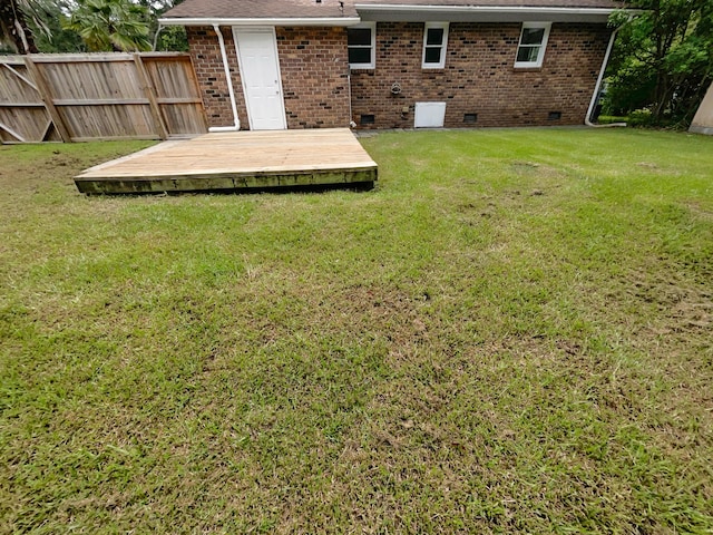 view of yard featuring a deck and fence