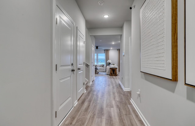 hall with light hardwood / wood-style floors