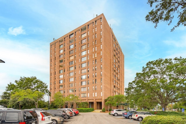 view of property featuring uncovered parking