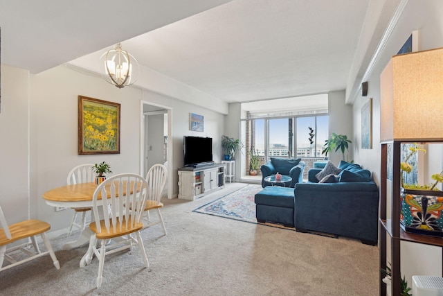 carpeted living room with an inviting chandelier and a wall of windows