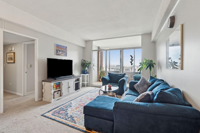 living area with light carpet, expansive windows, and baseboards