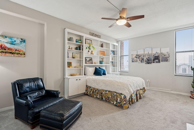 bedroom with a textured ceiling, carpet floors, and baseboards