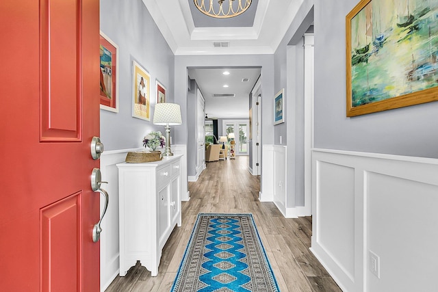 554 Tidewater Chase Ln, Summerville, SC 29486 - entrance foyer featuring light wood-type flooring, wainscoting, a raised ceiling, a chandelier, and a decorative wall
