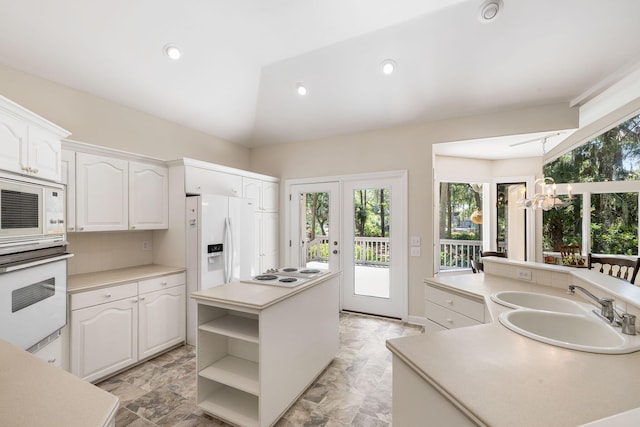 2938 Old Drake Dr, Seabrook Island, SC 29455 - kitchen featuring white appliances, a center island with sink, open shelves, white cabinets, and light countertops