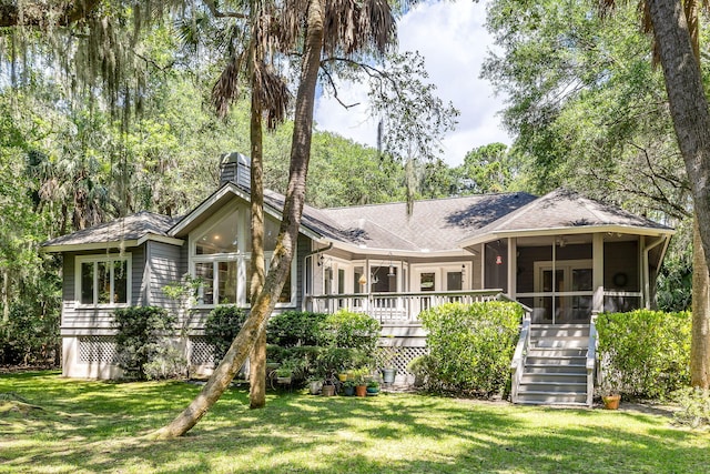 2938 Old Drake Dr, Seabrook Island, SC 29455 - view of front of property featuring a sunroom, a front lawn, stairway, and roof with shingles