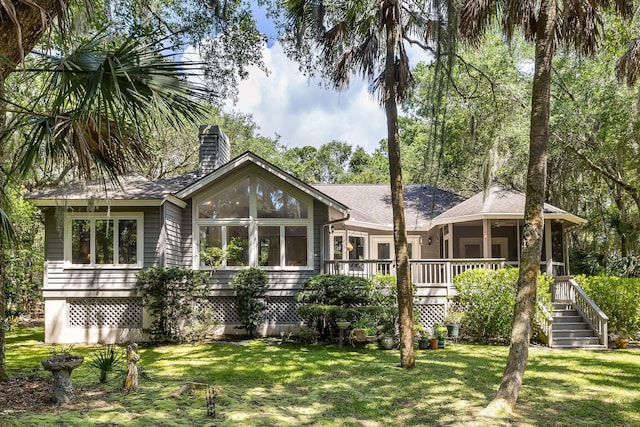 2938 Old Drake Dr, Seabrook Island, SC 29455 - back of property with a chimney, a lawn, and a deck