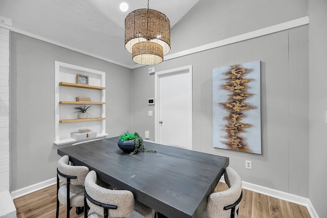 1393 Secessionville Rd, Charleston, SC 29412 - dining space with wood finished floors, a chandelier, vaulted ceiling, and built in shelves