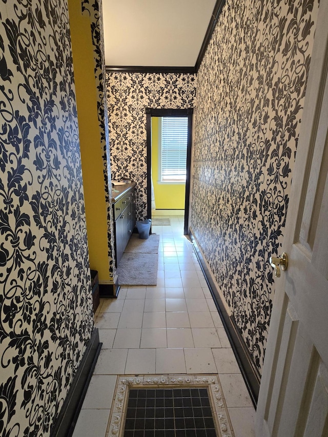 hall featuring ornamental molding and light tile patterned flooring