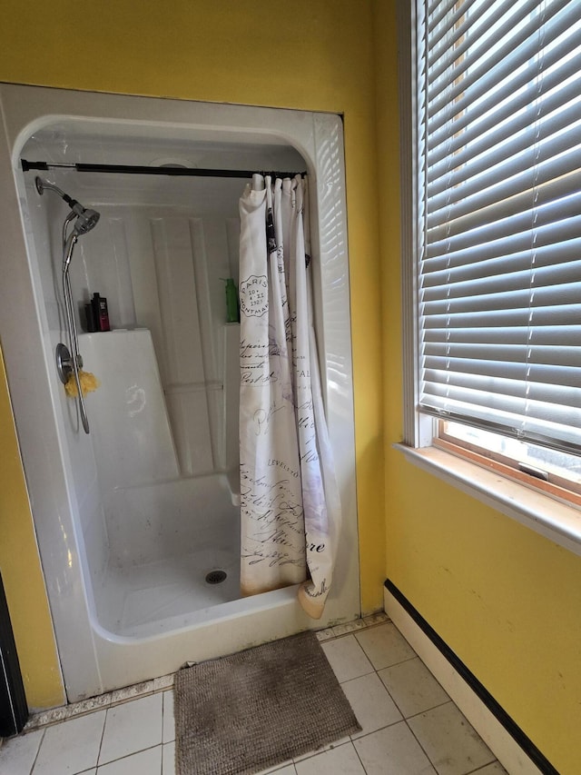 bathroom with tile patterned flooring, baseboard heating, and curtained shower