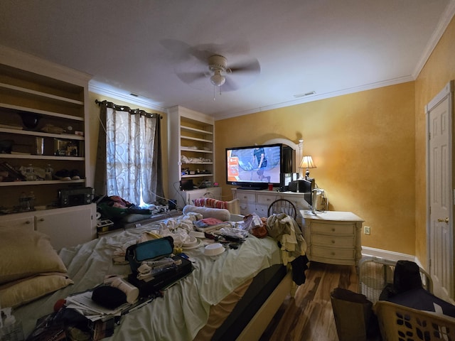 bedroom with ceiling fan, crown molding, and hardwood / wood-style flooring