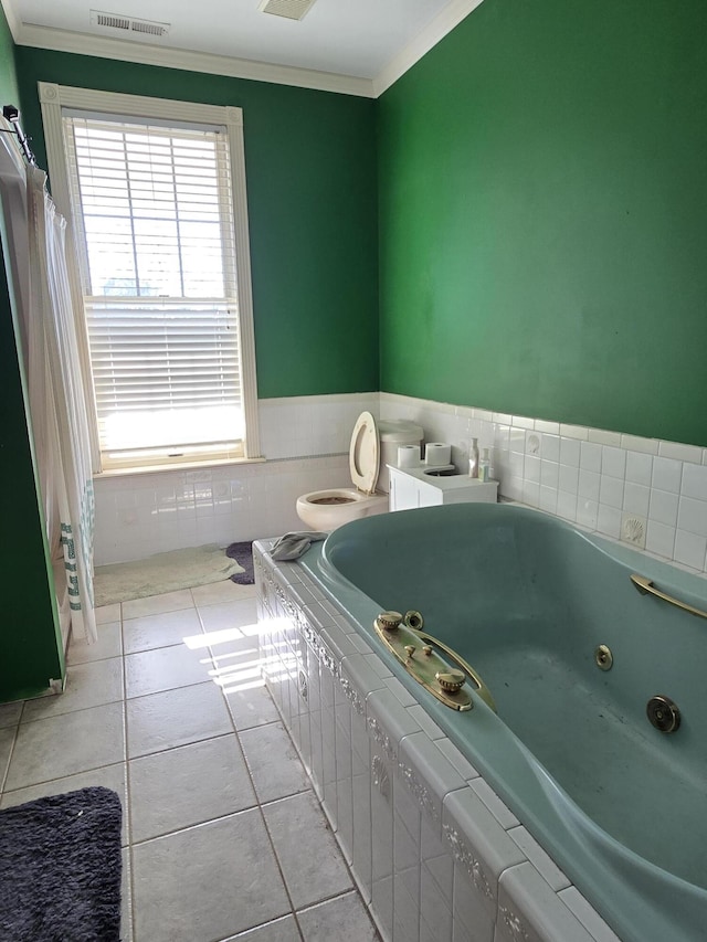 bathroom featuring tile patterned flooring, a bath, and crown molding