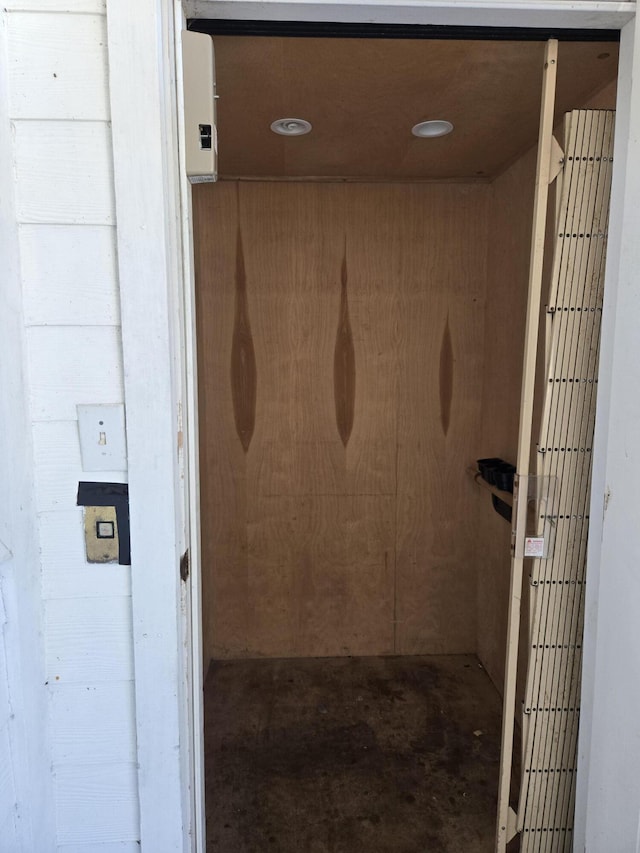 bathroom featuring concrete floors and elevator