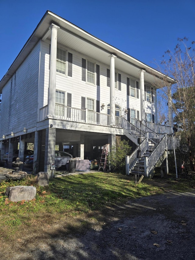 rear view of property with a porch and a carport