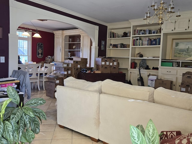 living room featuring light tile patterned flooring, crown molding, and an inviting chandelier