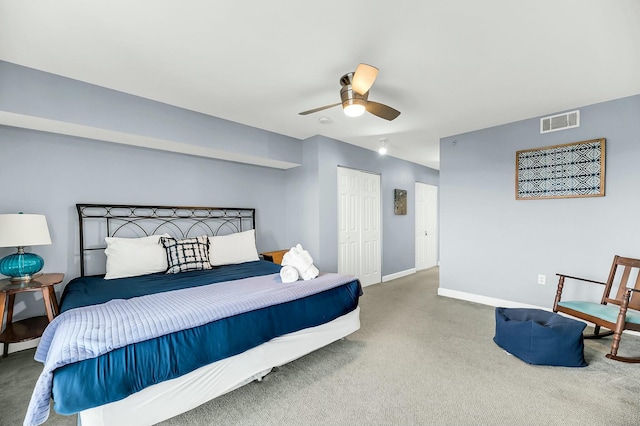 carpeted bedroom with a closet and ceiling fan