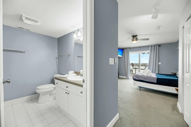 bathroom with vanity, toilet, and ceiling fan