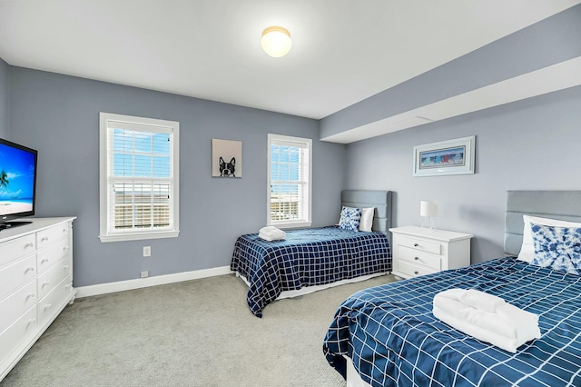 carpeted bedroom with multiple windows