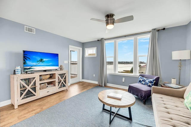 living room featuring ceiling fan and wood-type flooring