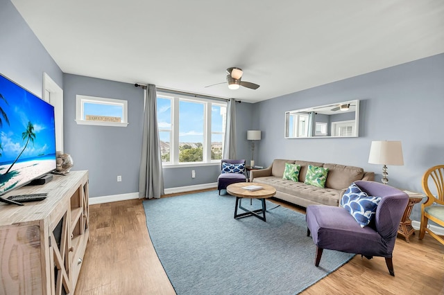 living room with ceiling fan and hardwood / wood-style flooring