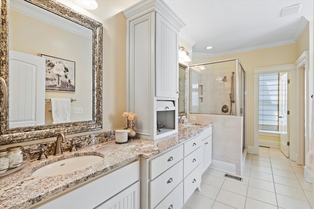 bathroom with a stall shower, tile patterned flooring, double vanity, and crown molding