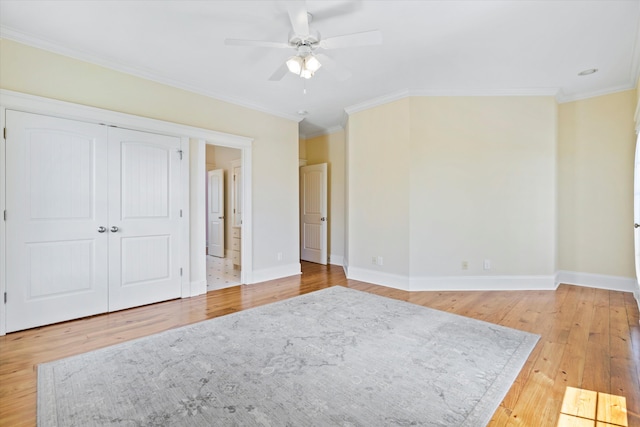 unfurnished bedroom with light wood-style flooring, baseboards, crown molding, and ceiling fan
