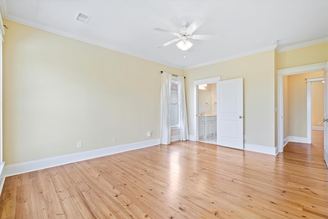 unfurnished bedroom with crown molding, light wood finished floors, baseboards, and connected bathroom