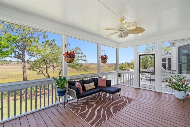 sunroom featuring ceiling fan